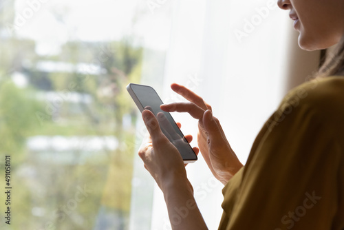 Smart phone screen with empty mock up close up view over female shoulder, user of new mobile application, electronic business app usage, texting message, writes e-mail, distance communication concept