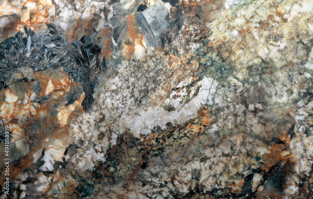 Texture of natural gray quartz stone with orange mineral inclusions.