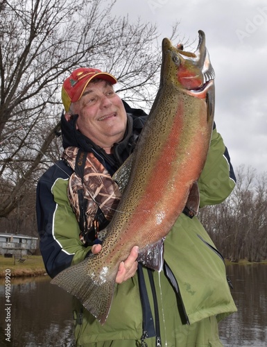 An angler with a colorful male steelhead 