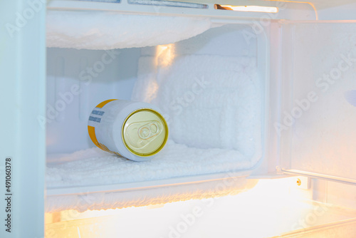 cans of beer were immersed in the freezer of the refrigerator,