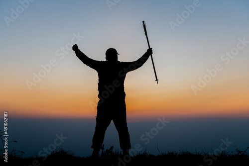 silhouette of man standing on the mountain,success concept scene