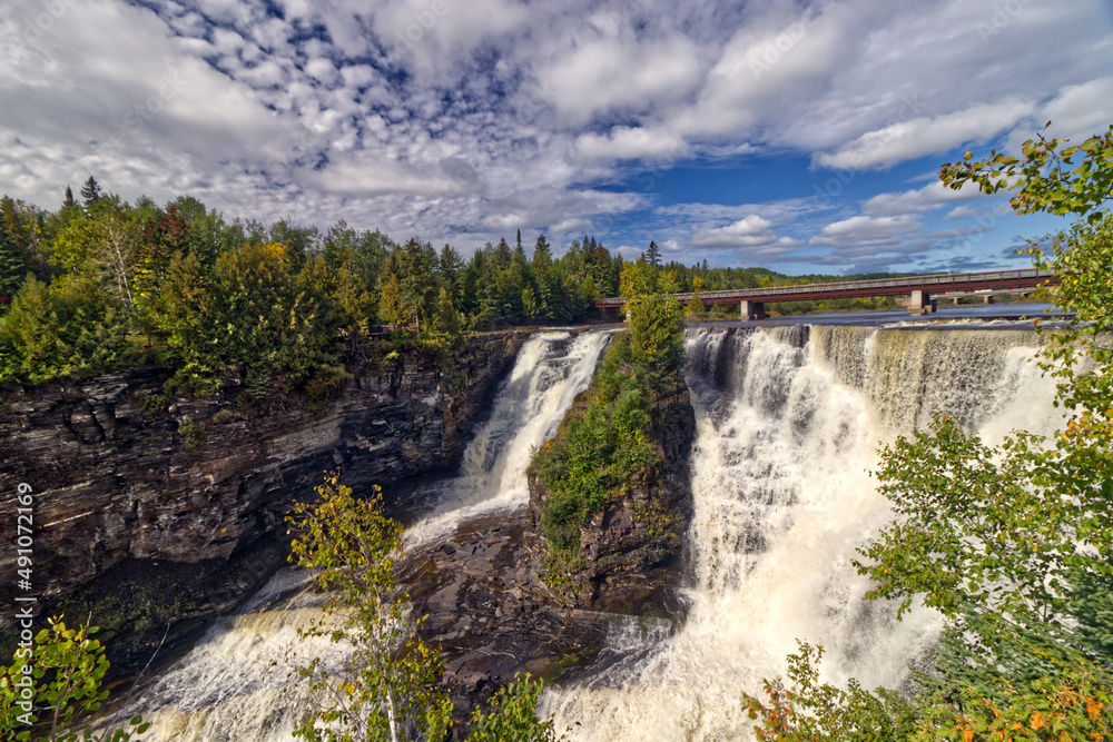 Fototapeta premium The morning sun beating down the falls - Kakabeka Falls, Thunder Bay, ON, Canada