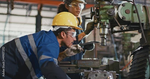 Blue-collar Worker. team of technician and engineer are checking machinery in operation in industrial plant team work of repair inspector complete maintenance of machine equipment