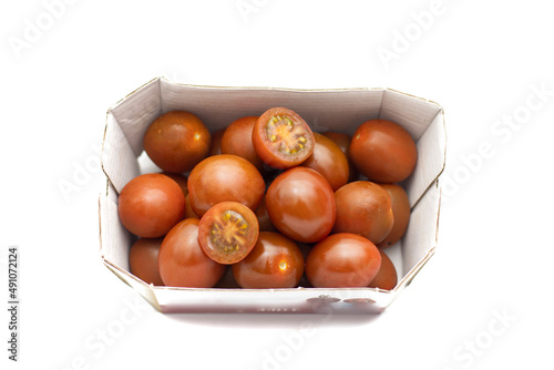 A carton of cherry tomatoes, the mini kumato variety. Isolated on white background. photo