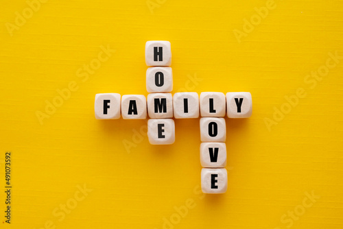 Принти на полотні The word family over wooden cubes, yellow background