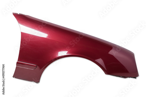 Red metallic fender on a white isolated background in a photo studio for sale or replacement in a car service. Mudguard on auto-parsing for repair or a device to protect the body from dirt photo