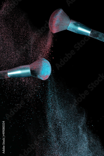 Make up brushes colliding and exploding with powder