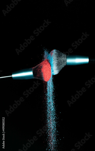 Make up brushes colliding and exploding with powder