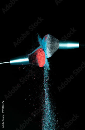Make up brushes colliding and exploding with powder