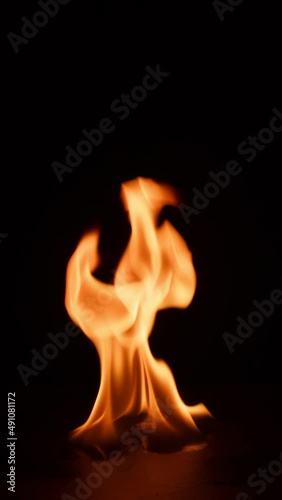 fire bruning on black slate stone. Hot Elements for compositing vertical photo