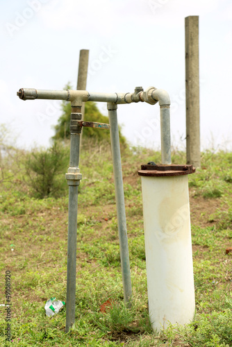 Fototapeta Naklejka Na Ścianę i Meble -  Groundwater well with pvc pipe and system electric deep well submersible pump water