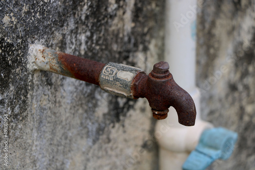 Portrait view of rustic broken water tap