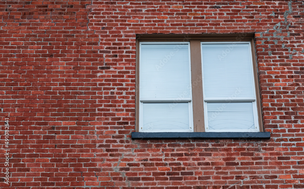 Window in Brick Wall. Window with closed blinds in a urban red bricks clinker house. Window in Brick Wall. Window with closed blinds in a urban red bricks clinker house.