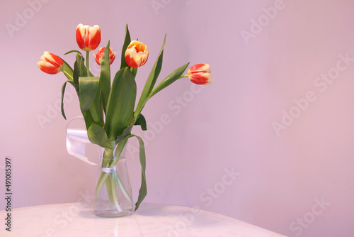 Fototapeta Naklejka Na Ścianę i Meble -  Spring flowers - tulips, on the table in a glass vase