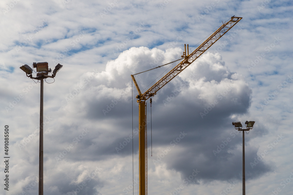 construction, sky, blue, light, lamp, crane, weather, wind, industry, metal, street, electricity, tower, power, pole, electric, energy, clouds, equipment, technology, building, lamppost, post, steel, 