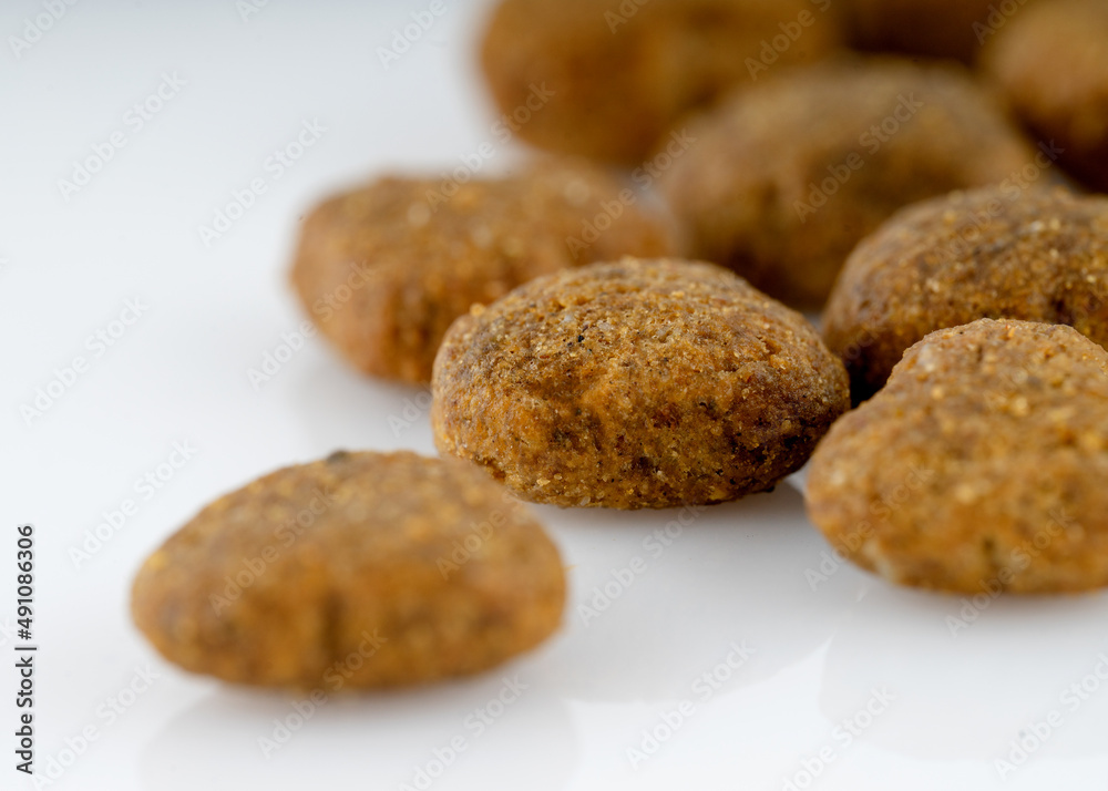 close up of dog food pellets on white background close up of dog food pellets on white background