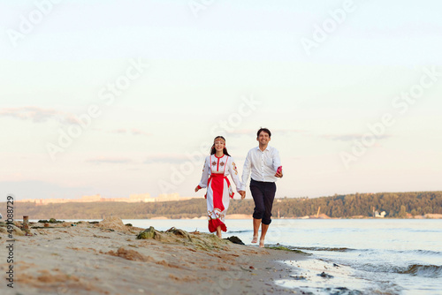 a girl in national Chuvash clothes and her boyfriend on the river bank