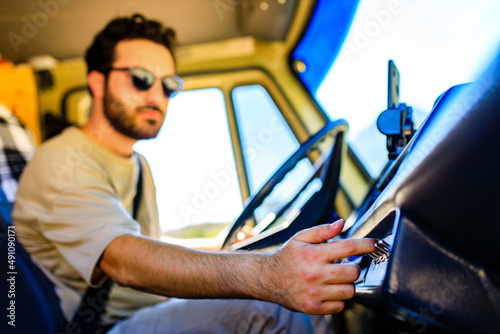 Portrait of young bearded trucker in his truck vehicle house