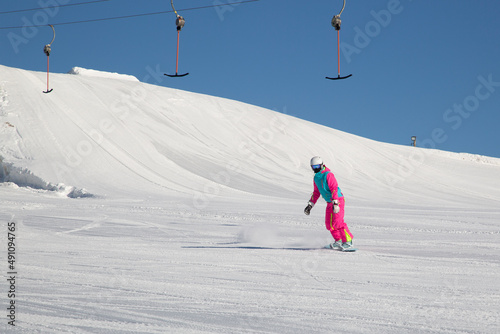 Snowboarder and Snowboard. A snowboarder goes snowboarding downhill in winter.