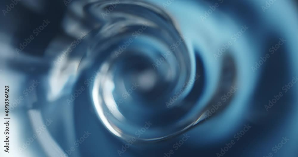 Overhead view of a spinning vortex of water or fast flowing whirlpool.