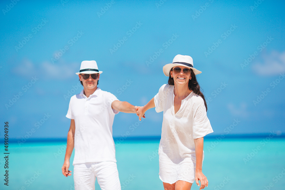 Young Family on white beach during summer vacation. Young Family on white beach during summer vacation.