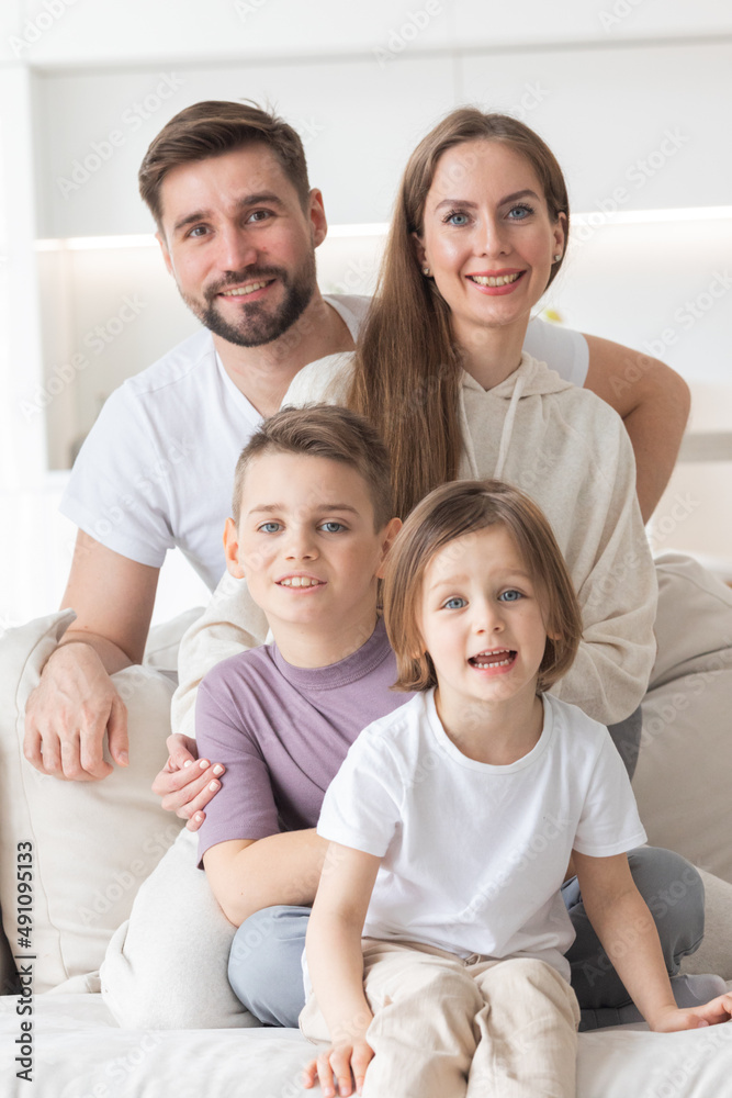 Happy family with children on sofa