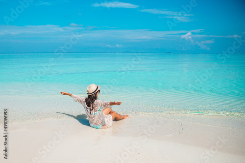 Young fashion woman in green dress on the beach