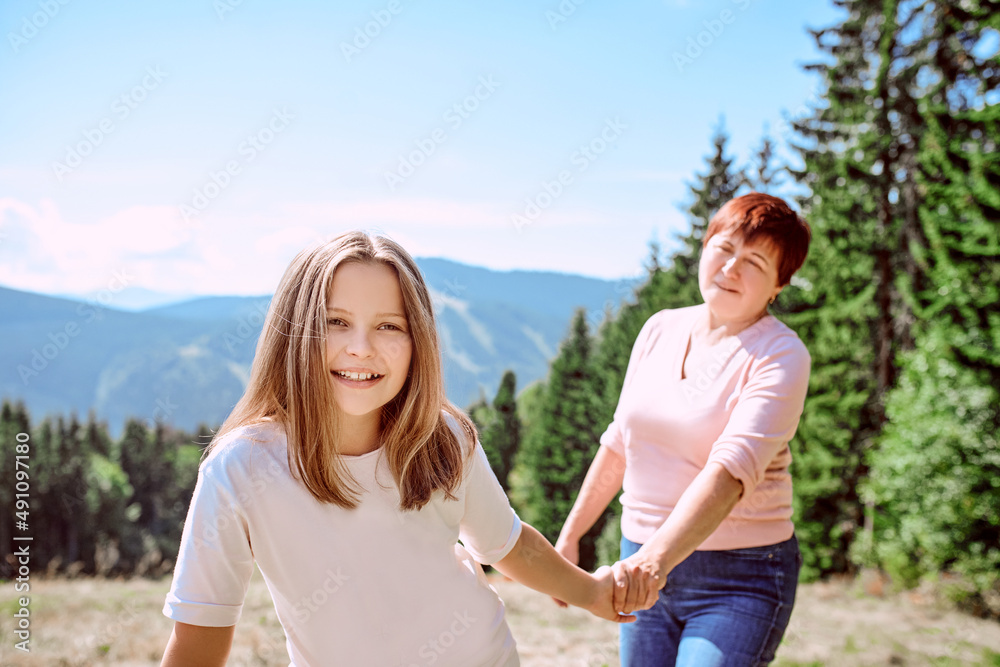 family grandmother and mother in mountains happy to travel. Leisure family time, summer concept