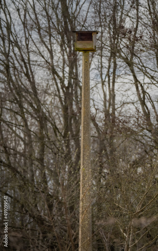 very large nesting box fitted atop an old concrete lamp post suitable for owls or Kestrels (Falco tinnunculus)