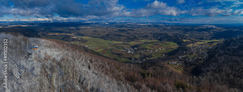 Wide panorama looking from Ostri vrh towards beautiful Radensko polje close to Grosuplje, Slovenia. Snow on the top, while green meadows at the bottom.