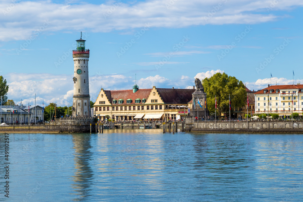 Lindau, Germany. Lighthouse and lion statue (19th century) at the entrance to the port