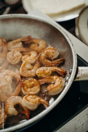 king prawns are fried in a frying pan with oil