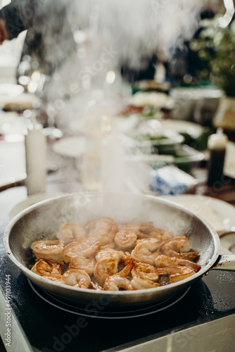 shrimp fried in a frying pan with smoke