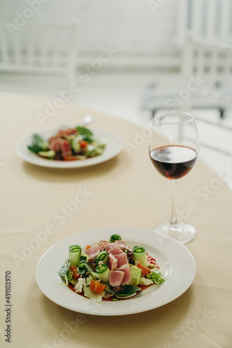nicoise salad with a glass of red wine