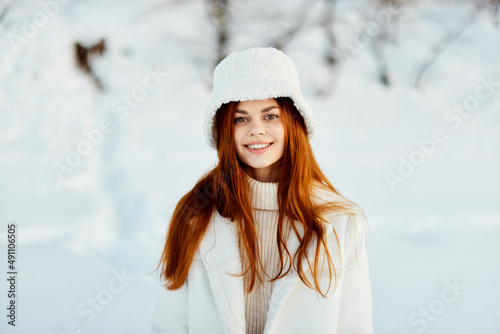 woman in a white coat in a hat winter landscape walk Lifestyle