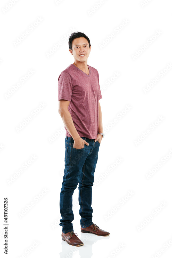 Keeping it casual in the studio. Studio portrait of a young man posing with his hands in his pockets against a white background. Keeping it casual in the studio. Studio portrait of a young man posing with his hands in his pockets against a white background.