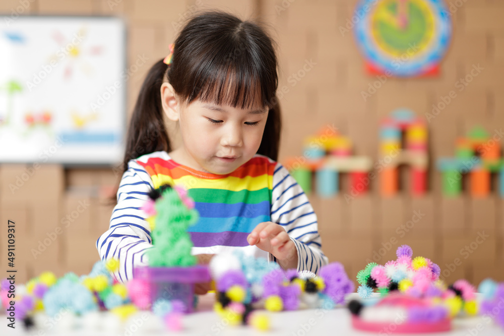young girl playing creative building ball toy at home young girl playing creative building ball toy at home