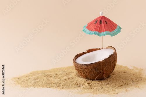 Wallpaper Mural  Creative composition with coconut and sun parasol. Tropical beach concept with half of coconut. Torontodigital.ca