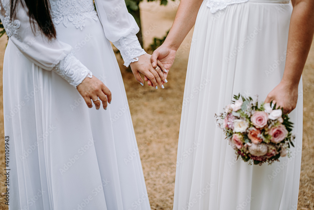 Lesbian brides holding wedding bouquets Lesbian brides holding wedding bouquets