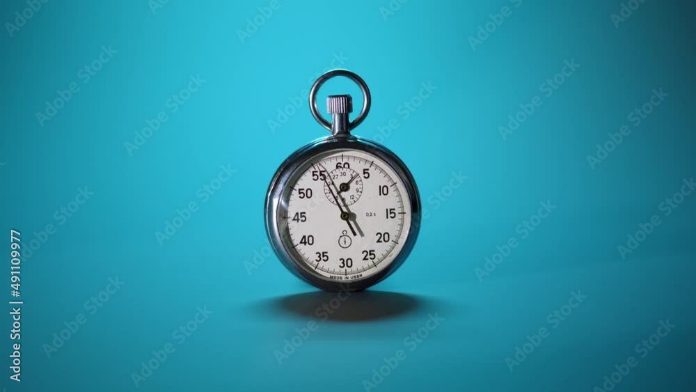 Close up chromed retro stopwatch counts down time to deadline of business processes. vintage stopwatch on blue background goes forward, time is run. End of countdown or start new minute. Close up chromed retro stopwatch counts down time to deadline of business processes. vintage stopwatch on blue background goes forward, time is run. End of countdown or start new minute.