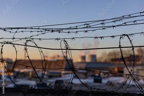 concrete fence with barbed wire in an industrial area