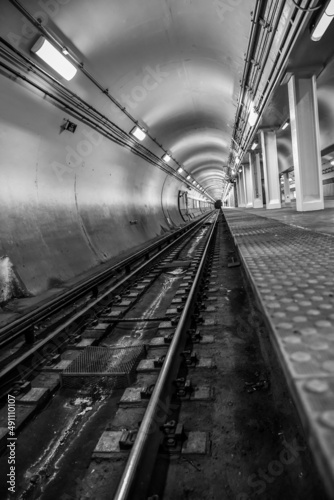 Empty underground commuter subway tunnel tracks