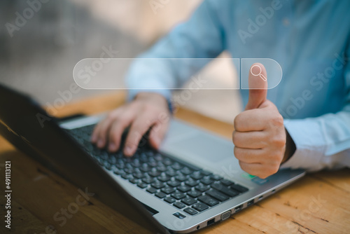 Search technology, search engine optimization,man's hand using laptop computer keyboard to search information,using search engine bar function on your website.People who work in cafes