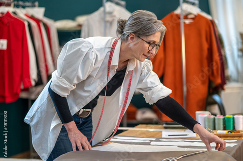 Woman bending over table touching pattern