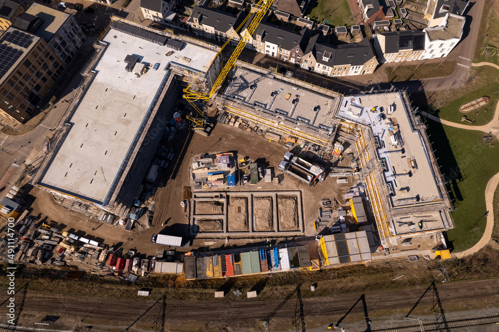 Top down view of construction site Ubuntuplein in urban development of real estate investment in Noorderhaven neighbourhood. Aerial housing and engineering concept.