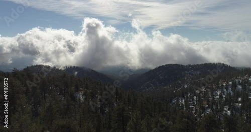 Aerial Footage over Forest in the mountains with clouds 