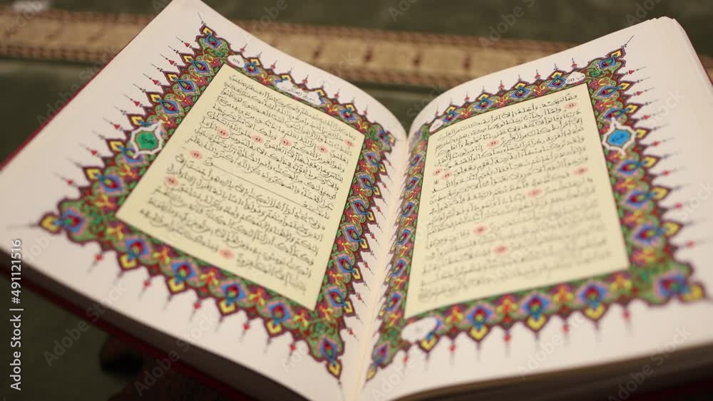 A shot of a beautiful opened Quran, the shot is slightly moving backward