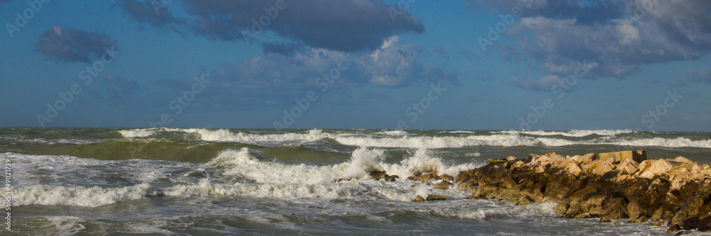 Photo from the cliff in winter with rough sea and sky with clouds in Abruzzo Italy. Adriatic Sea. Horizontal banner 