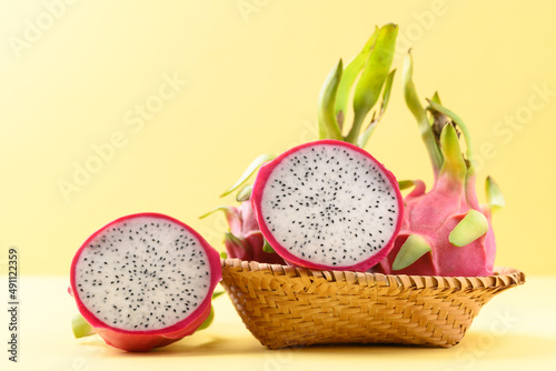 Fresh dragon fruit or pitaya in bamboo basket on yellow background, Tropical fruit