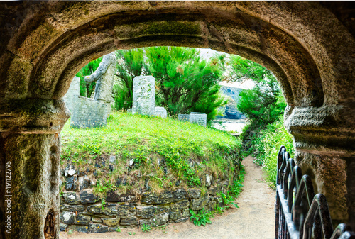 Ancient stone,arched entrance to Saint Winwaloe's Church,Cornwall,Gunwalloe,southwest England,UK. photo